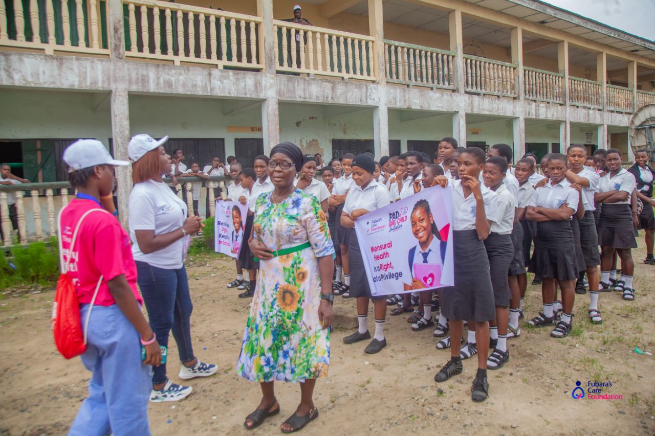 Students at Comprehensive Senior Secondary School, Opobo Town holding Pad a Girl Child banners