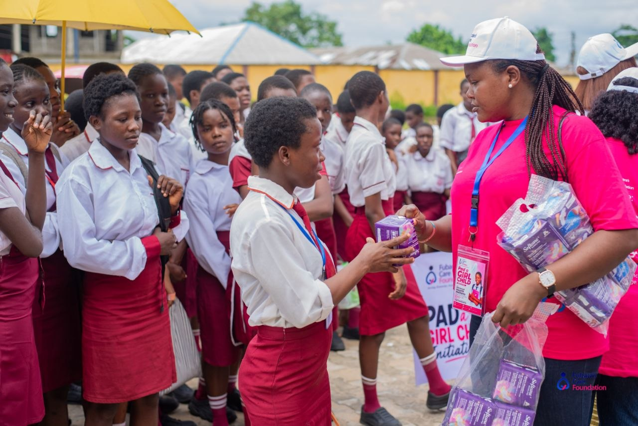 A student receiving her sanitary pad pack during the Pad a Girl Child Initiative at Akpajo