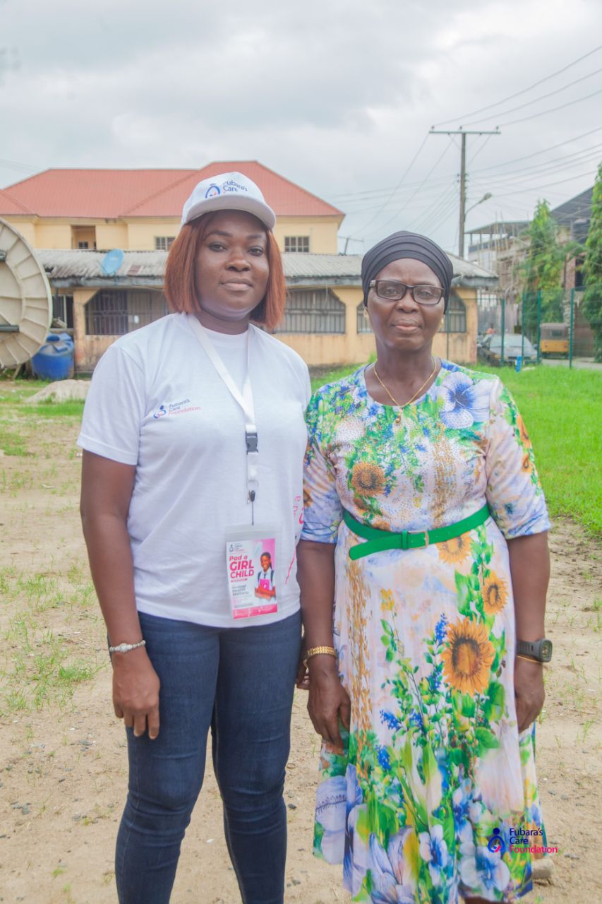 Fubara's Care Foundation volunteer with the school Principal in Opobo Town