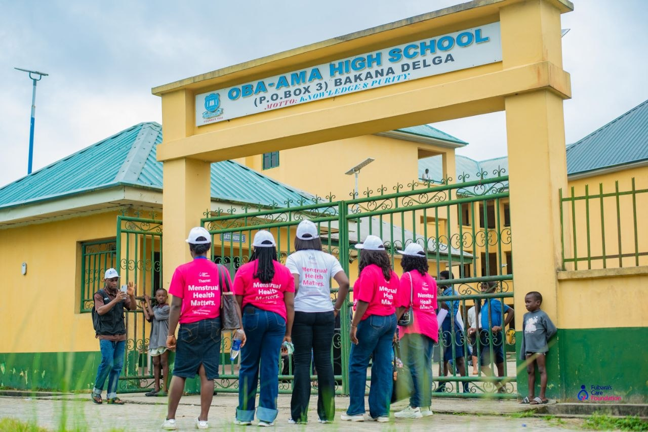Fubara's Care Foundation team in Menstrual Health Matters shirts arriving at the Oba-Ama High School gate, Bakana, Degema LGA