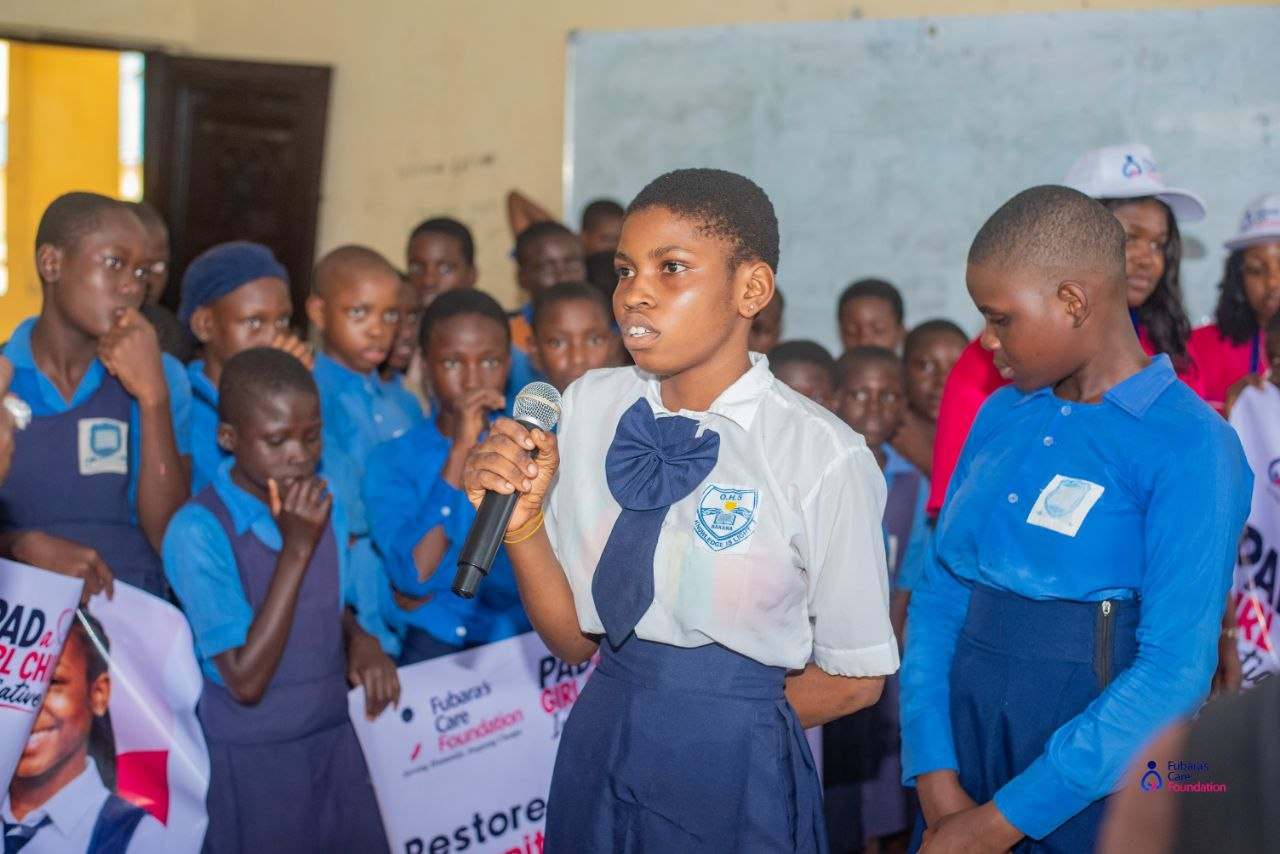 A student of Oba-Ama High School asking a question on the microphone during the menstrual health talk