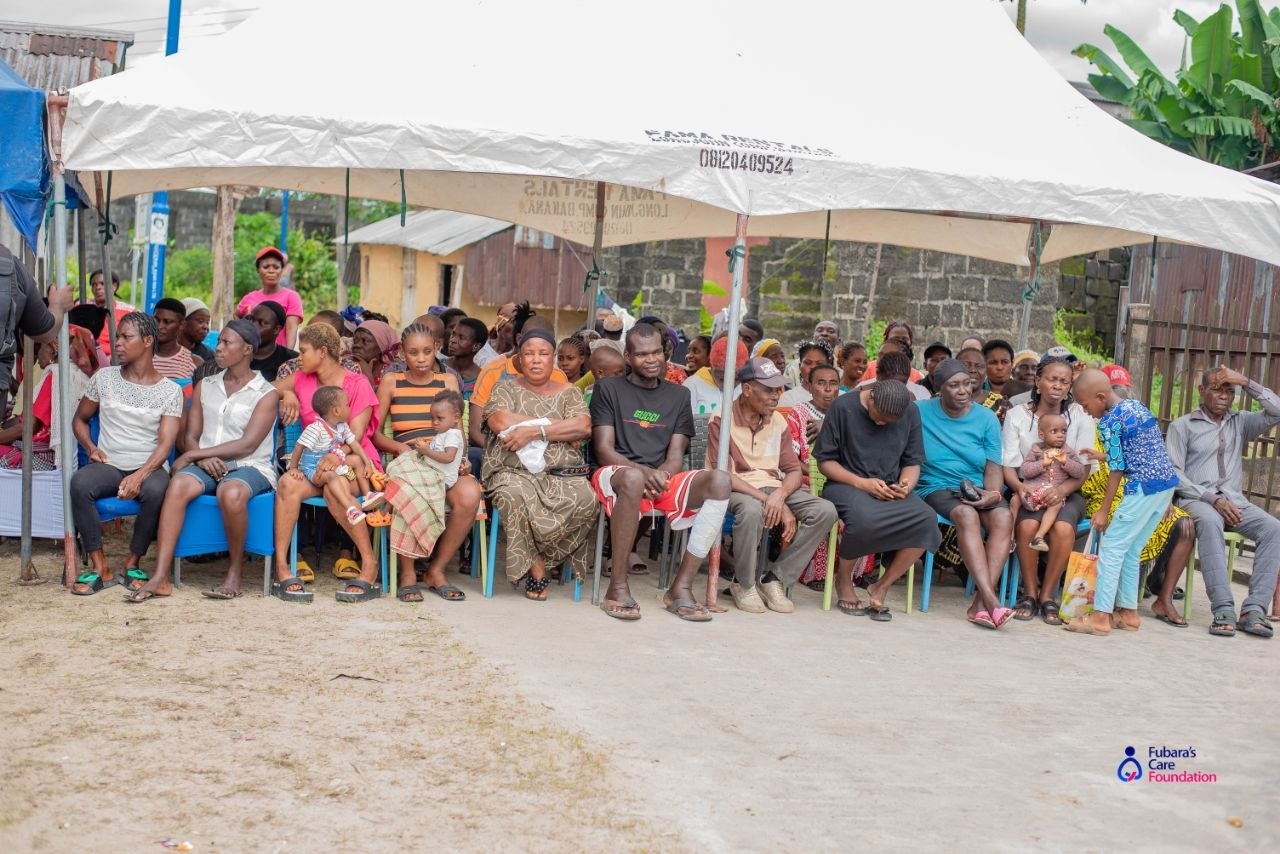 Families seated under the outreach tent awaiting free consultation at Boma Mingi Suku, Will-Braide Central