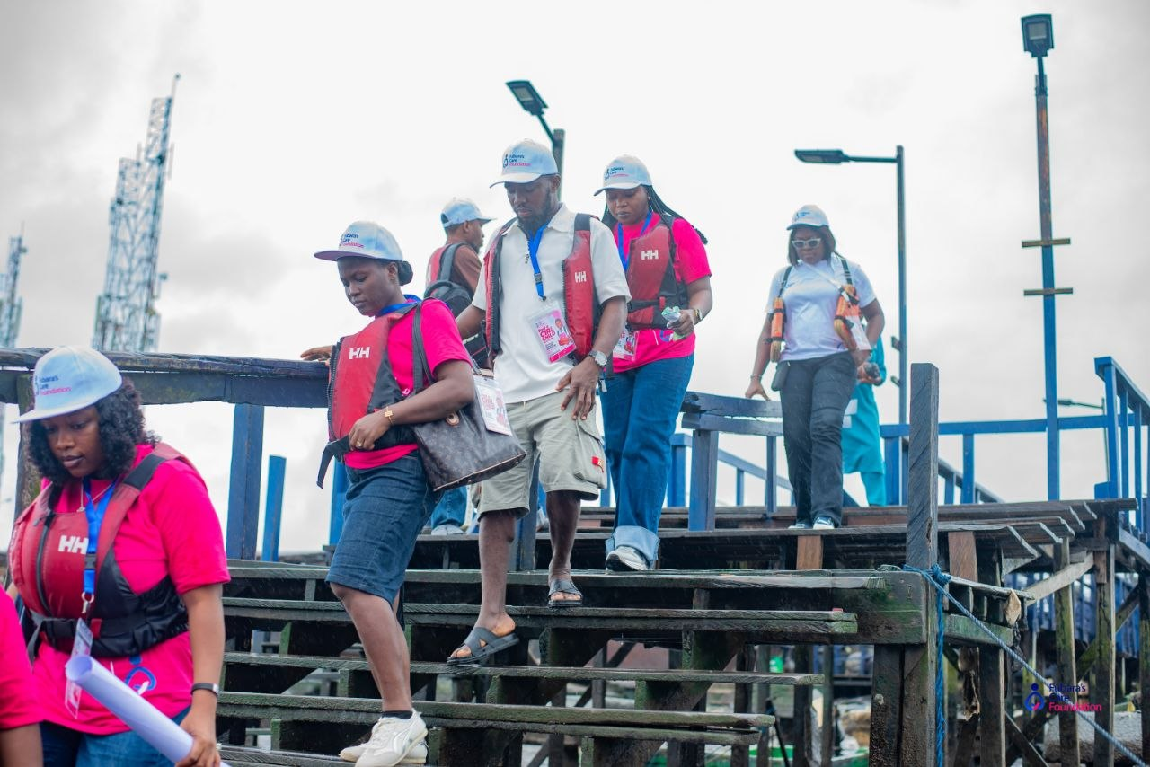 The Fubara's Care Foundation team crossing the Bakana waterfront jetty on their way to the Oba-Ama High School outreach