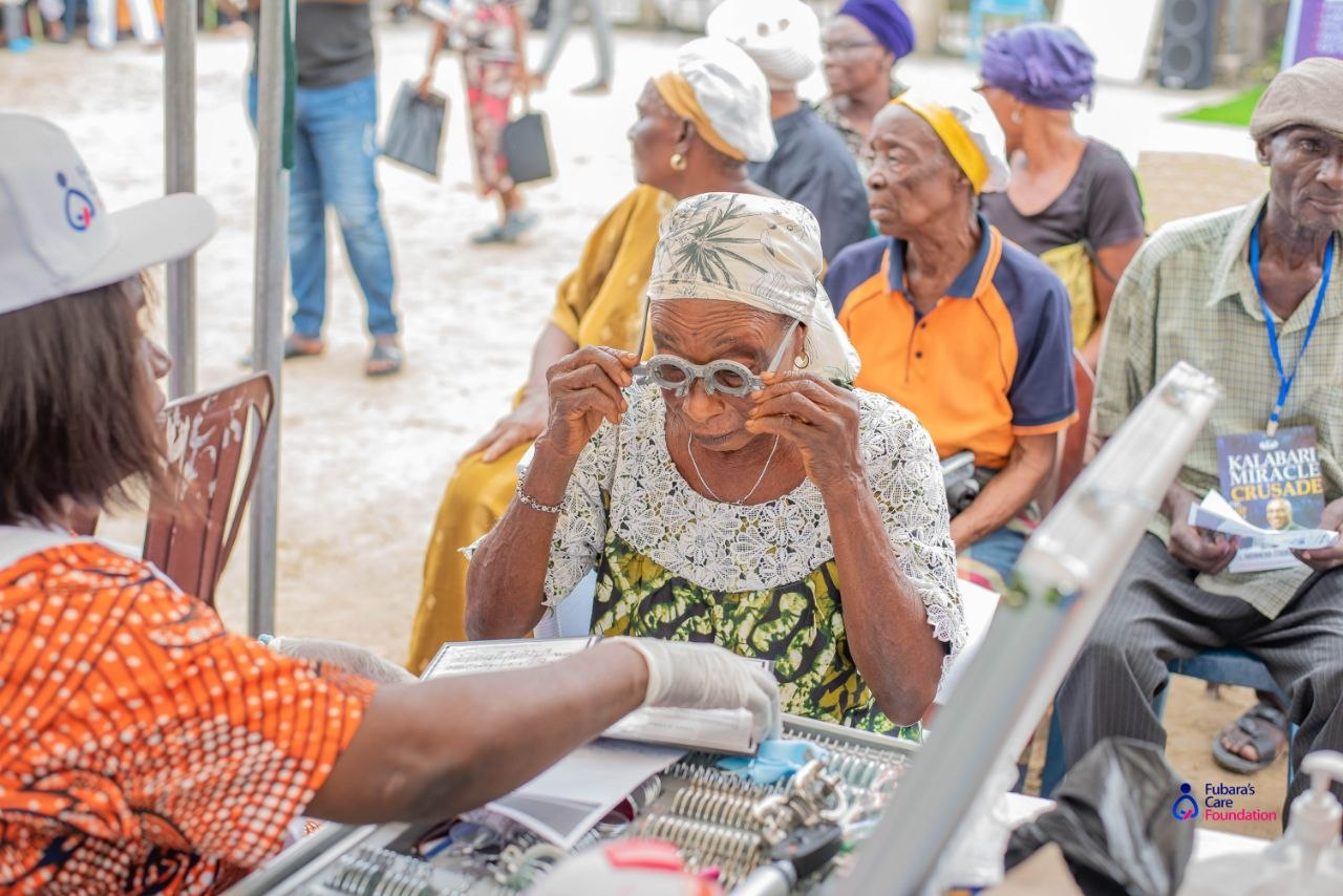 An elderly woman fitted with trial lenses during the free eye examination at the Bakana Free Medical Outreach