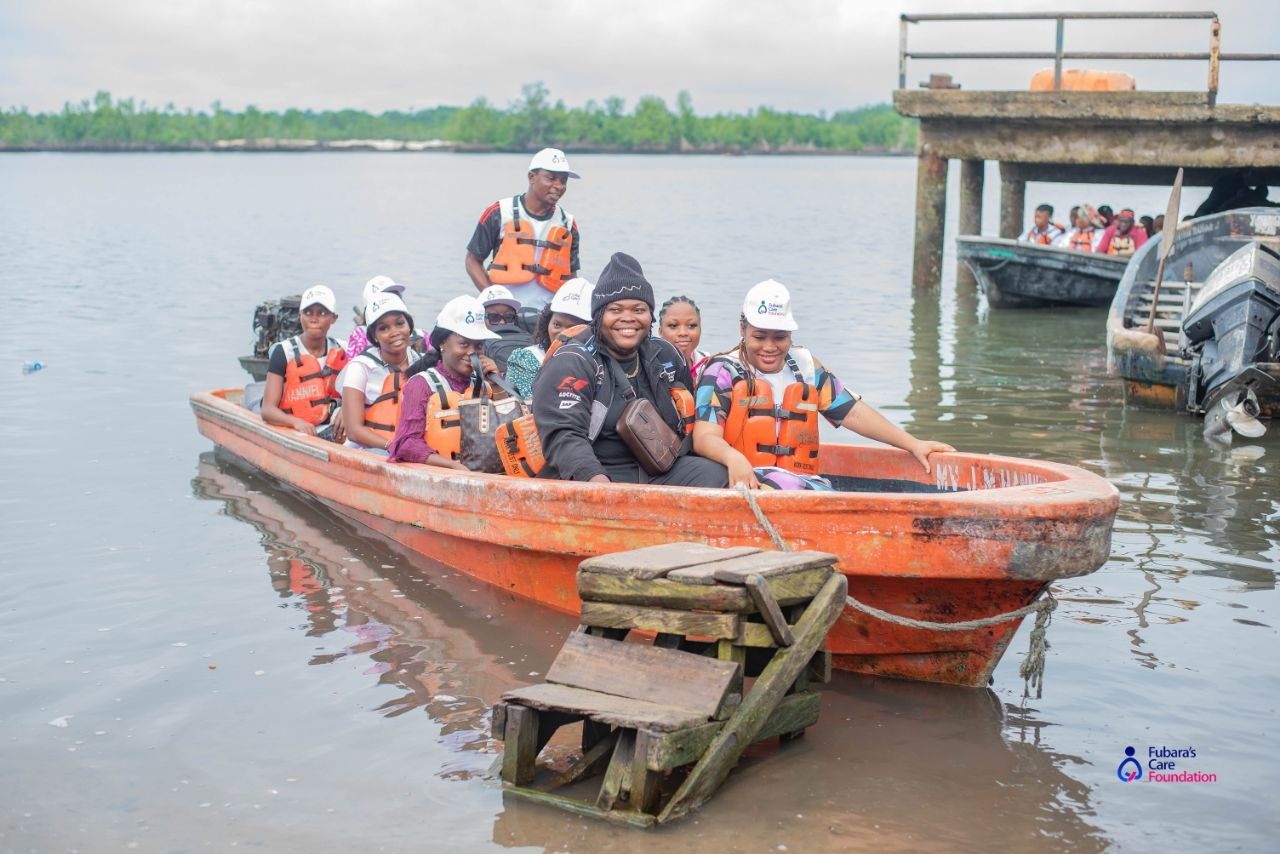 Volunteers travelling by boat across the creeks to Bakana Community, Rivers State, for the Free Medical Outreach